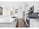 Open-concept kitchen featuring stainless steel appliances, stone countertops, and ample cabinet space at 229 N Church St # 100, Charlotte, NC 28202