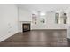 Bright living room with fireplace, hardwood floors, and large windows providing plenty of natural light at 229 N Church St # 100, Charlotte, NC 28202