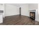 Open-concept living room with a fireplace and hardwood floors, offering a cozy and inviting atmosphere at 229 N Church St # 100, Charlotte, NC 28202