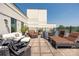 Spacious outdoor patio with lounge furniture, dining area, and views of the city at 229 N Church St # 100, Charlotte, NC 28202