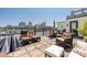 Outdoor patio features dining and lounge areas with skyline views at 229 N Church St # 100, Charlotte, NC 28202