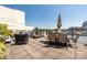 Relaxing outdoor patio featuring lounge chairs, tables and seating with a cityscape in the background at 229 N Church St # 100, Charlotte, NC 28202