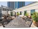 Expansive outdoor patio with dining and lounge areas and large windows overlooking the city at 229 N Church St # 100, Charlotte, NC 28202