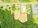 This aerial perspective outlines the property, highlighting its proximity to a road, building, and open fields at 24132 Nc Hwy 73 Hwy, Albemarle, NC 28001