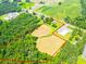 Aerial view of acreage for sale with surrounding trees and bordering a paved road at 24132 Nc Hwy 73 Hwy, Albemarle, NC 28001