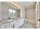 Bright bathroom featuring double sinks, granite counters, and a shower-tub combo at 2830 Grosbeak Ln, Charlotte, NC 28269