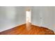 A bright bedroom featuring hardwood floors and neutral paint, ready for personalization at 2830 Grosbeak Ln, Charlotte, NC 28269