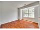 Bright bedroom featuring hardwood floors and large window for plenty of natural light at 2830 Grosbeak Ln, Charlotte, NC 28269