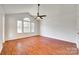 Vaulted bedroom featuring hardwood floors, a ceiling fan and plenty of natural light from the large windows at 2830 Grosbeak Ln, Charlotte, NC 28269