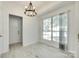 The dining area has modern chandelier lighting, bright windows, and wood look floors, ideal for entertaining at 2830 Grosbeak Ln, Charlotte, NC 28269