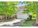 Two-story home with attached garage, neutral siding, manicured shrubs, and a well-maintained lawn at 2830 Grosbeak Ln, Charlotte, NC 28269