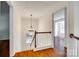 Bright upstairs hallway features hardwood floors, white railing, and an elegant chandelier at 2830 Grosbeak Ln, Charlotte, NC 28269