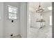 This functional space features clean white walls, flooring, with adjacent kitchen, and natural light from window at 2830 Grosbeak Ln, Charlotte, NC 28269