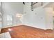 Bright and airy living room, featuring wood floors, a staircase and tall ceilings for a luxurious feel at 2830 Grosbeak Ln, Charlotte, NC 28269