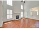 Open living space with fireplace, high ceilings and large windows, seamlessly blends comfort and style at 2830 Grosbeak Ln, Charlotte, NC 28269