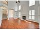 Spacious living room with a fireplace and large windows with plantation shutters and wood floors at 2830 Grosbeak Ln, Charlotte, NC 28269