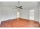 Spacious primary bedroom featuring hardwood floors and ensuite bathroom and closet access at 2830 Grosbeak Ln, Charlotte, NC 28269