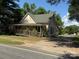 A well-maintained single-story home with a quaint front porch and lush green surroundings at 2944 N Lookout St, Claremont, NC 28610