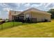 Expansive backyard with a well-maintained lawn, secure fencing, and a charming outdoor patio at 3006 Constitution Ln, Gastonia, NC 28056