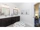 Bathroom featuring a dual vanity, decorative mirrors, and stylish decor with an adjacent sitting area at 3006 Constitution Ln, Gastonia, NC 28056