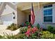 Inviting home entrance with American flag, manicured landscaping, and brick facade at 3006 Constitution Ln, Gastonia, NC 28056