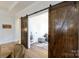 Rustic barn doors open to a light-filled home office with wood flooring and natural light at 3006 Constitution Ln, Gastonia, NC 28056