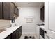 Spacious laundry room with dark cabinets, white countertops, sink, and modern washer at 3006 Constitution Ln, Gastonia, NC 28056