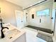 Beautiful primary bathroom showcasing a spacious walk-in shower with sleek black hardware and a double vanity at 305 Pleasant Hill Se Dr, Concord, NC 28025