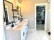Well-lit bathroom with double sinks, quartz counters, and a view of the large walk-in closet for ample storage at 305 Pleasant Hill Se Dr, Concord, NC 28025