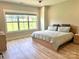 Bright bedroom with hardwood floors, a modern bed, a ceiling fan, and a large window offering ample natural light at 305 Pleasant Hill Se Dr, Concord, NC 28025