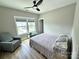 Inviting bedroom with large windows, ceiling fan, and cozy seating area, designed for comfort and relaxation at 305 Pleasant Hill Se Dr, Concord, NC 28025