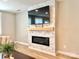 Close-up of a modern stone fireplace with a flat screen television above the wooden mantel at 305 Pleasant Hill Se Dr, Concord, NC 28025