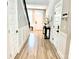 Inviting foyer with wood-like floors, a modern table with decor, and a staircase with black handrail at 305 Pleasant Hill Se Dr, Concord, NC 28025