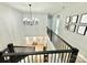 Elegant foyer with staircase, featuring hardwood floors and a decorative chandelier, creating a grand entrance at 305 Pleasant Hill Se Dr, Concord, NC 28025