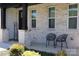 Cozy front porch with chairs, brick accents, and a 'Welcome' sign, creating an inviting entrance at 305 Pleasant Hill Se Dr, Concord, NC 28025