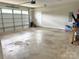 Spacious garage with white door, concrete floor, and side access door at 305 Pleasant Hill Se Dr, Concord, NC 28025