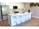 Bright kitchen with white cabinets, stainless steel appliances, and a quartz island with seating at 305 Pleasant Hill Se Dr, Concord, NC 28025