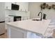 Close-up of kitchen island with quartz countertop, a black faucet, and modern seating at 305 Pleasant Hill Se Dr, Concord, NC 28025