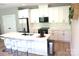Bright kitchen with white cabinets, stainless steel appliances, and a quartz island with seating at 305 Pleasant Hill Se Dr, Concord, NC 28025