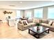 Open-concept living room with a large sofa, kitchen island, and dining area, perfect for entertaining at 305 Pleasant Hill Se Dr, Concord, NC 28025