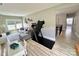 Open living room features a sofa, home gym, and view to the upstairs hallway at 305 Pleasant Hill Se Dr, Concord, NC 28025
