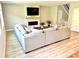 Bright living room features a stone fireplace, large sectional sofa, and modern flooring at 305 Pleasant Hill Se Dr, Concord, NC 28025