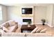 Cozy living room featuring a stone fireplace, comfortable seating, and a large television for relaxation at 305 Pleasant Hill Se Dr, Concord, NC 28025