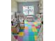 Fun playroom with colorful floors, play kitchen, and lots of toys for to explore and be creative at 305 Pleasant Hill Se Dr, Concord, NC 28025