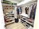 Organized walk-in closet with shelves, hanging rods, and storage baskets for efficient organization of clothing and accessories at 305 Pleasant Hill Se Dr, Concord, NC 28025