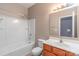 Well-lit bathroom with a combination shower-tub and a wooden vanity at 3296 Saddlebrook Dr, Midland, NC 28107