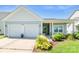 Inviting single-story home featuring a two-car garage, manicured lawn, and charming entrance at 3296 Saddlebrook Dr, Midland, NC 28107