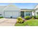 Inviting single-story home featuring a two-car garage, manicured lawn, and charming entrance at 3296 Saddlebrook Dr, Midland, NC 28107