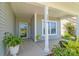 Inviting front porch with white pillars, plants, and visible house number at 3296 Saddlebrook Dr, Midland, NC 28107