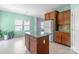 Kitchen with island, stainless steel appliances, and adjoining breakfast nook bathed in natural light at 3296 Saddlebrook Dr, Midland, NC 28107